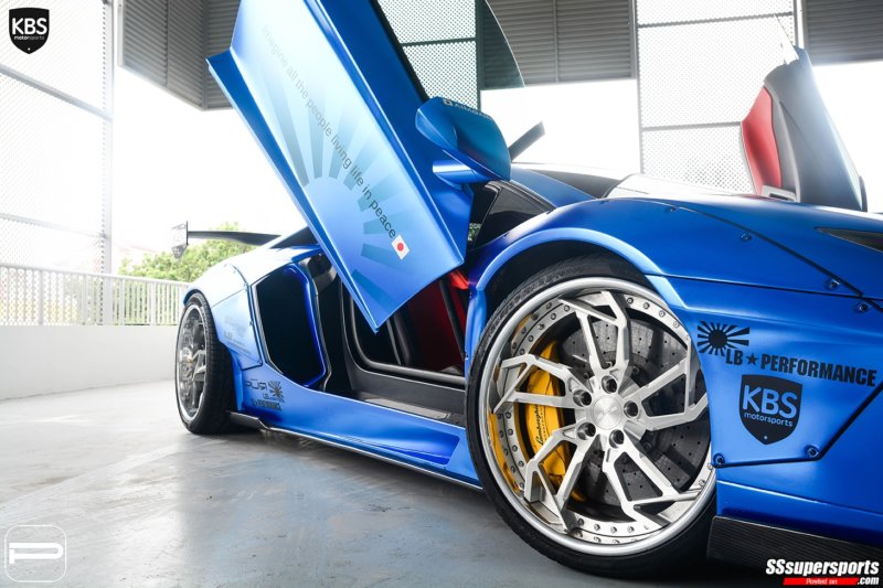 9-chrome-blue-liberty-walk-lamborghini-aventador-pur-wheels-front-side-angle-doors-up-front-wheel-yellow-caliper